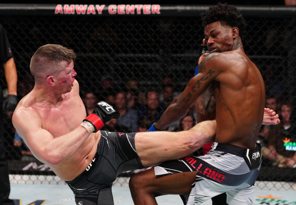 ORLANDO, FLORIDA - DECEMBER 03: (L-R) Stephen Thompson kicks Kevin Holland in a welterweight fight during the UFC Fight Night event at Amway Center on December 03, 2022 in Orlando, Florida. (Photo by Jeff Bottari/Zuffa LLC)