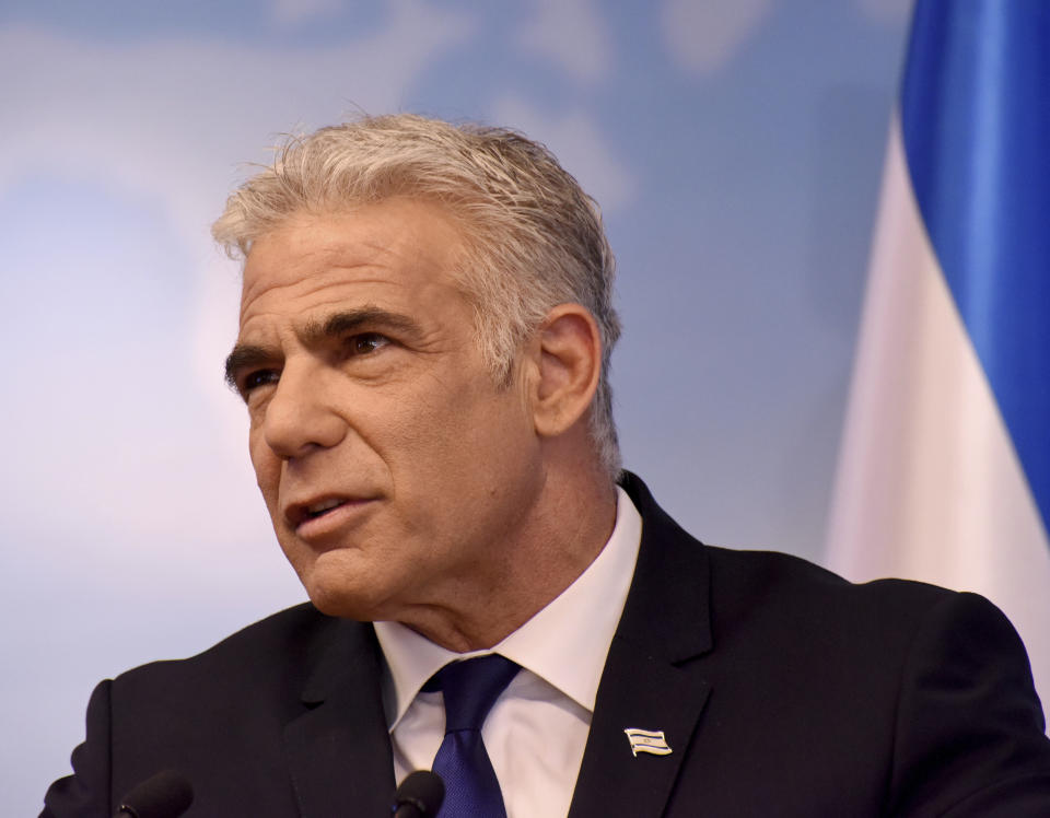 Israeli Foreign Minister Yair Lapid gives a press briefing at the foreign ministry in Jerusalem, Sunday, April 24, 2022. (Debbie Hill/Pool via AP)