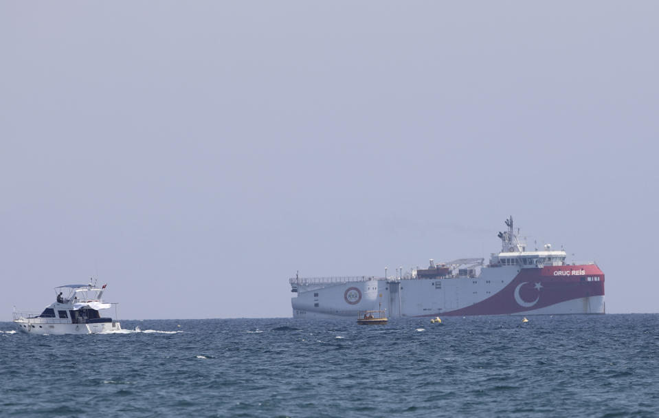 In this photo taken Monday, July 27, 2020, Turkey's research vessel, Oruc Reis, anchored off the coast of Antalya on the Mediterranean, Turkey. A top Turkish official said Tuesday that Turkey will suspend research for oil and gas exploration in disputed waters in the Eastern Mediterranean. President Recep Tayyip Erdogan told his aides to "be constructive and put this on hold for some time," presidential spokesman Ibrahim Kalin told Turkish broadcaster CNN Turk.(AP Photo/Burhan Ozbilici)