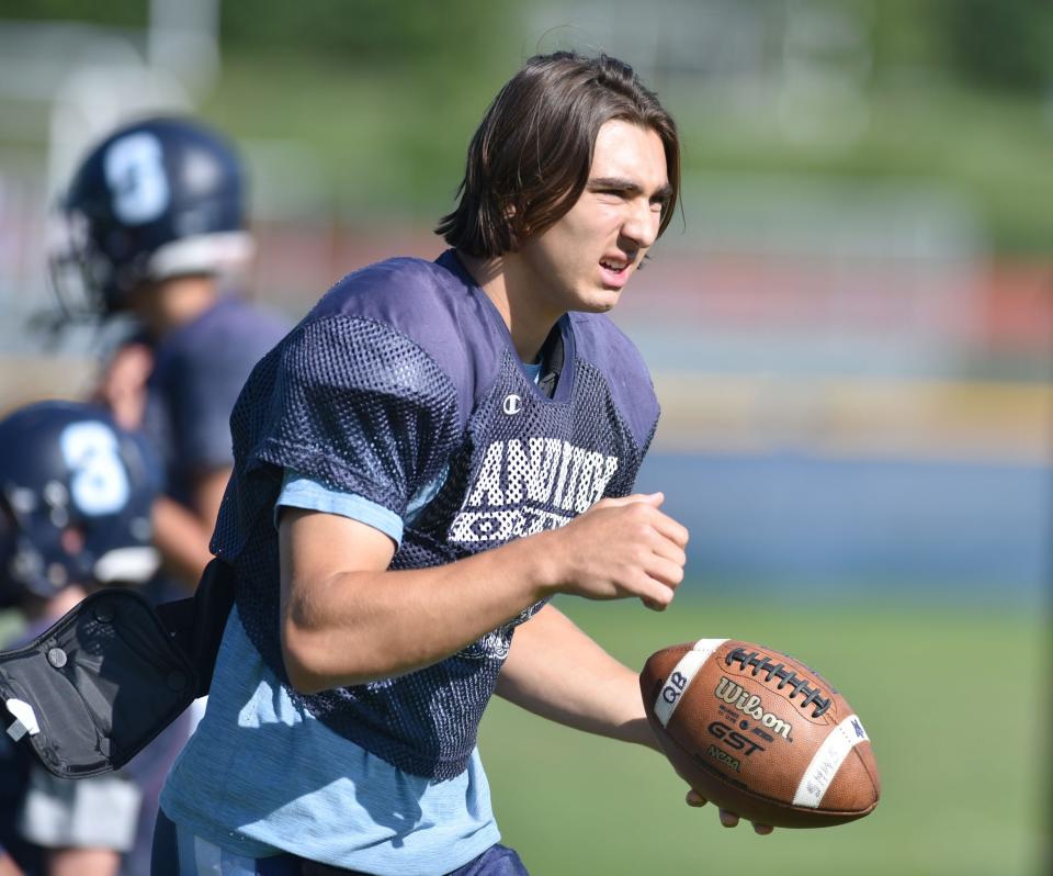 Junior Adam Ferreira warms up his arm ahead of a morning practice for the Sandwich High School football team.
