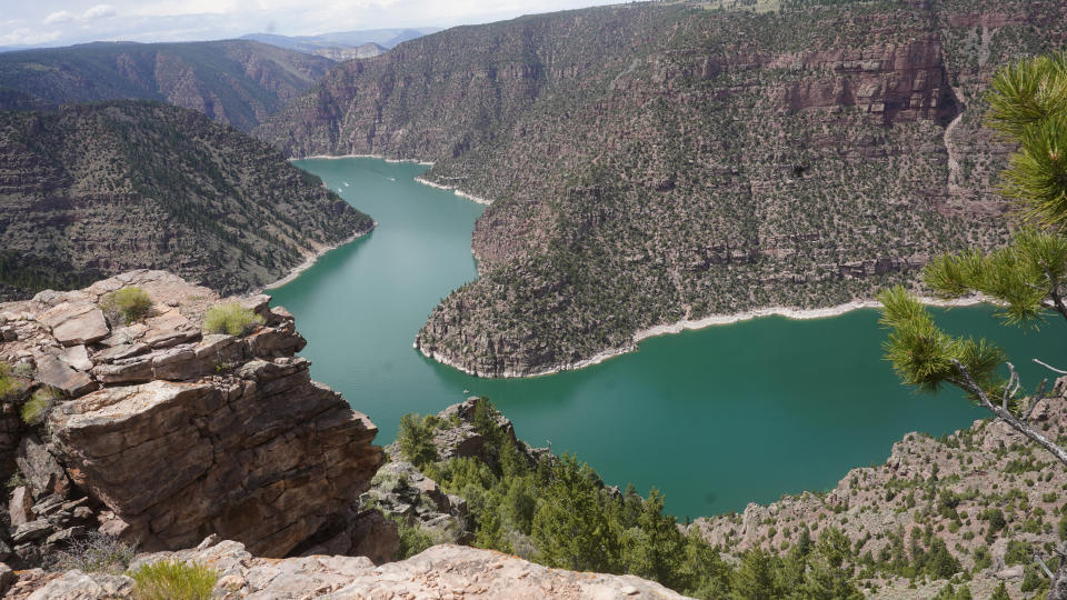 Jet skis move through Red Canyon on Friday, Aug. 5, 2022, in Flaming Gorge National Recreation Area, in the northeastern corner of Utah. A boating and fishing paradise on the Utah-Wyoming line, Flaming Gorge Reservoir is beginning to feel the effects of the two-decade megadrought gripping the southwestern U.S. (AP Photo/Rick Bowmer)