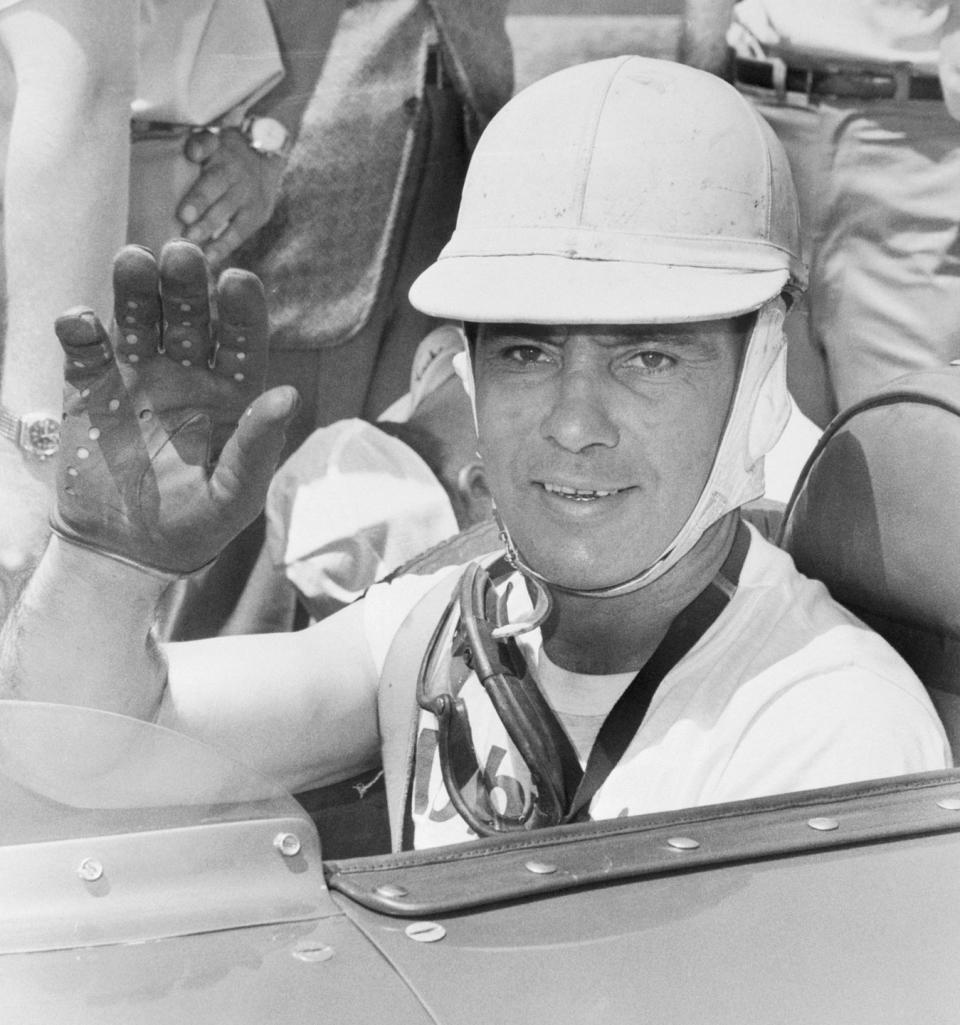 race car driver bill vuokovich waving from car