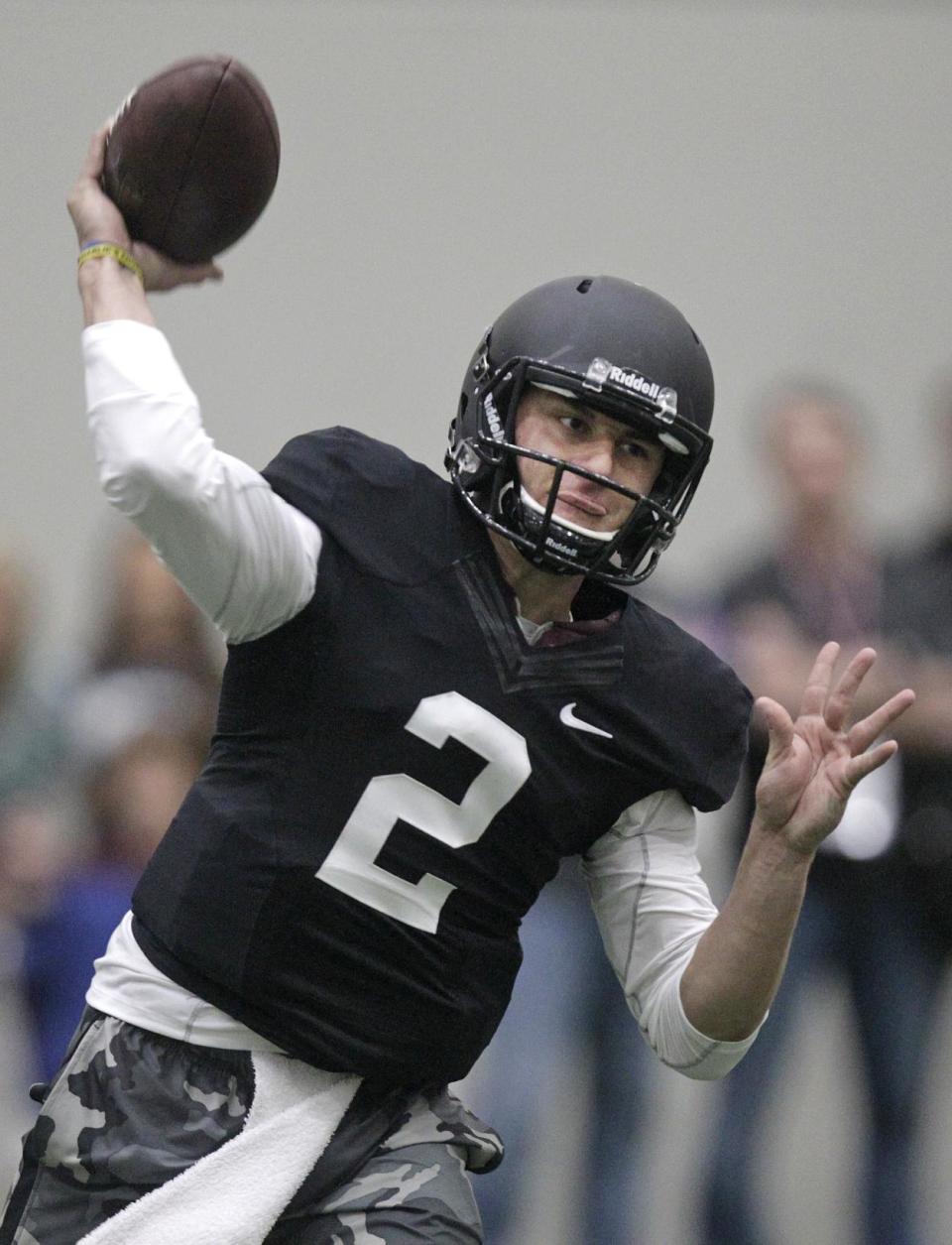 Texas A&M quarterback Johnny Manziel passes the ball during a drill at pro day for NFL football representatives in College Station, Texas, Thursday, March 27, 2014. (AP Photo/Patric Schneider)