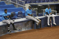 FILE - In this July 12, 2020, file photo, Miami Marlins' Jonathan Villar, left, Jesus Aguilar, center, and Jon Berti wait to bat during a baseball scrimmage at Marlins Park in Miami. Marlins CEO Derek Jeter blamed the team's coronavirus outbreak on a collective false sense of security that made players lax about social distancing and wearing masks. Infected were 21 members of the team's traveling party, including at least 18 players. None is seriously ill, Jeter said Monday, and he expects all to return this season. (AP Photo/Lynne Sladky, File)