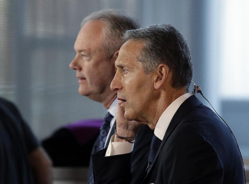 Starbucks CEO Howard Schultz, right, sits with President and Chief Operating Officer Kevin Johnson for a television interview before the company's annual shareholder meeting, Wednesday, March 22, 2017, in Seattle. Johnson takes over as CEO from Schultz, who will become executive chairman, in April. (AP Photo/Elaine Thompson)