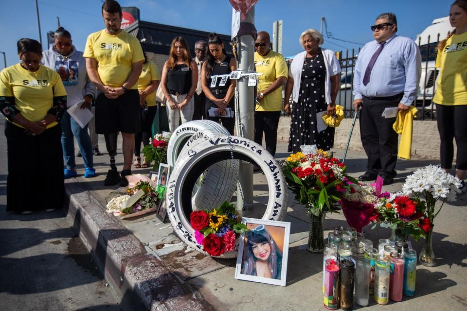 Representatives of Streets are for Everyone, a nonprofit traffic-safety advocacy group, place three white tires for a ``Ghost Tire Memorial" on Thursday, Aug. 31, 2023, near the location where three women were killed in a traffic collision while riding in an Uber in Los Angeles.