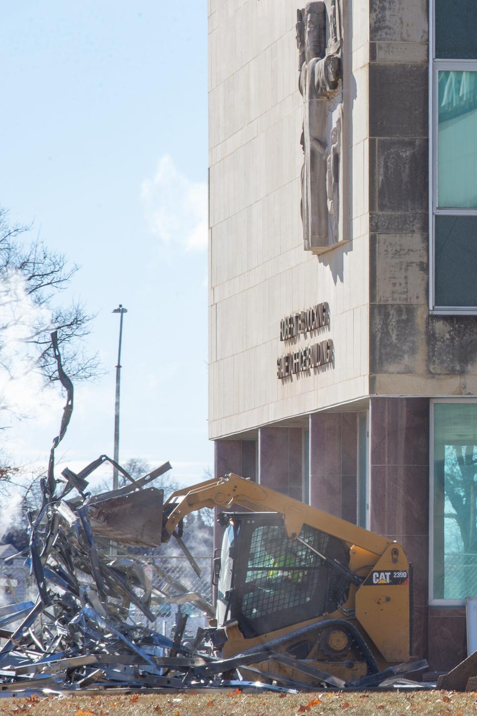 A construction worker removed scrap metal from the Docking State Office Building at 915 S.W. Harrison St. on Wednesday afternoon.