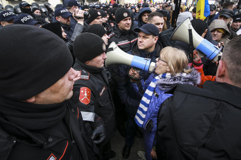 A woman yells through a bullhorn during a protest initiated by the Movement for the People and members of Moldova's Russia-friendly Shor Party, against the pro-Western government and low living standards, in Chisinau, Moldova, Tuesday, Feb. 28, 2023. Thousands of protesters returned to Moldova's capital Tuesday to demand that the country'snew pro-Western governmentfully subsidize citizens' winter energy bills amid skyrocketing inflation. (AP Photo/Aurel Obreja)