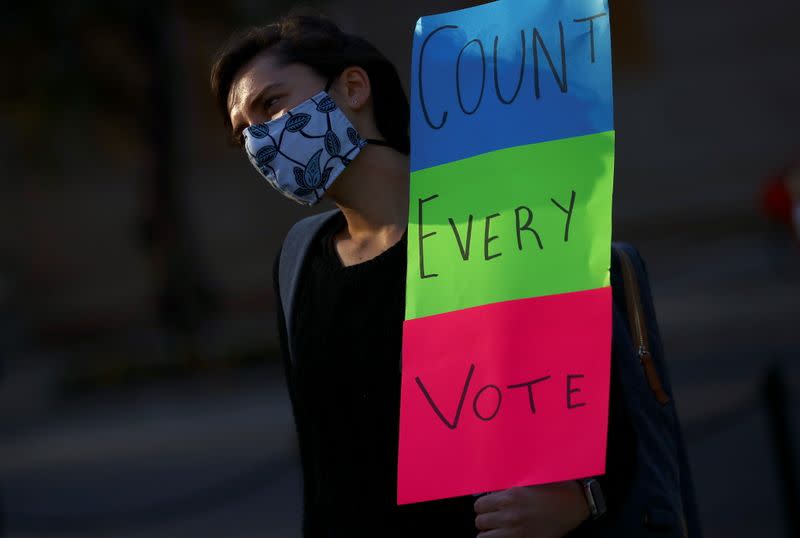 A person holds a placard near the White House after Election Day in Washington