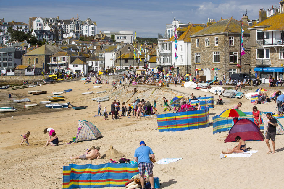 Holiday makers on the beach in St Ives, Cornwall, UK.