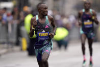 Evans Chebet, of Kenya, left, glances back while running ahead of Benson Kipruto, of Kenya, right, as they make their way along the course of the 127th Boston Marathon, Monday, April 17, 2023, in Boston. Chebet went on to win the race. (AP Photo/Steven Senne)