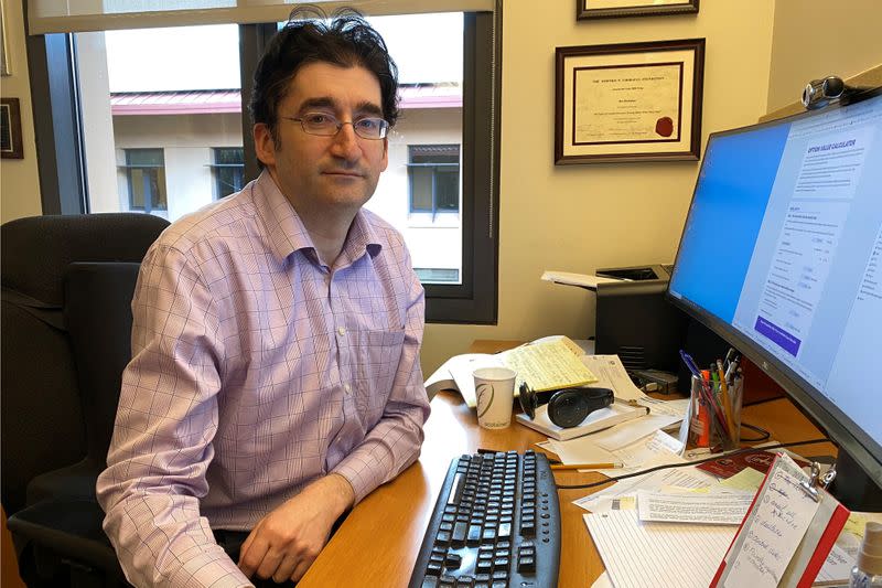 Stanford Graduate School of Business professor Ilya Strebulaev poses while showing a new online calculator