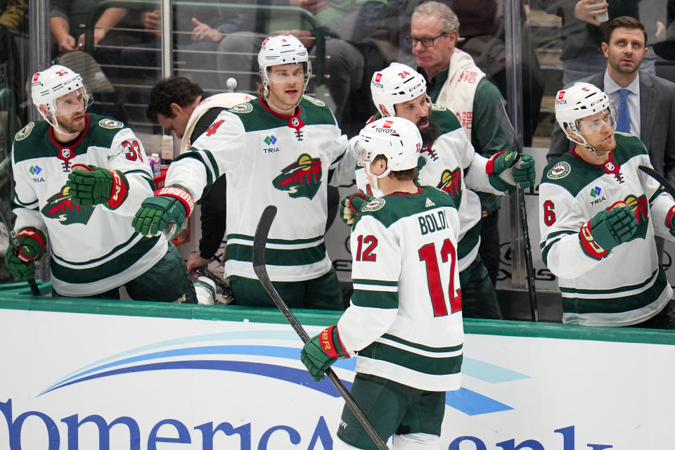 Minnesota Wild left wing Matt Boldy (12) skates by his bench after scoring a goal on the Dallas Stars during the third period of an NHL hockey game, Wednesday, Jan. 10, 2024, in Dallas. The Stars won 7-2. (AP Photo/Julio Cortez)