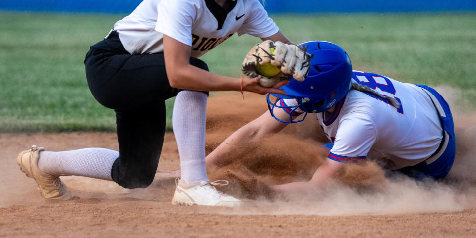 Roncalli Royals Natalie Summers (18) is safe after a sliding play at second during the IHSAA class 4A regional championship on Tuesday, May 30, 2023, at Roncalli High School in Indianapolis.