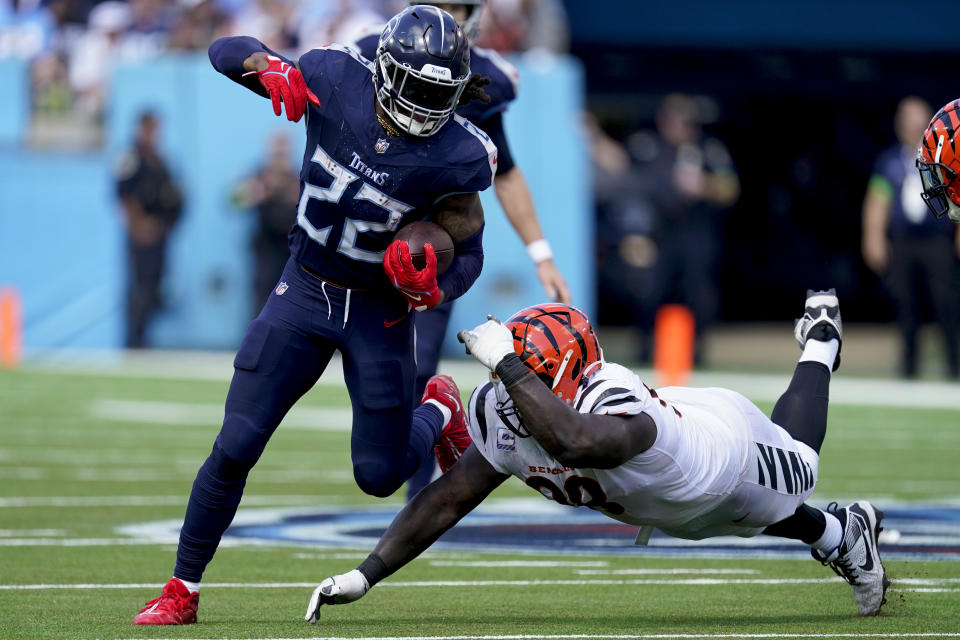 Tennessee Titans running back Derrick Henry (22) runs past Cincinnati Bengals defensive tackle Josh Tupou (68) during the second half of an NFL football game, Sunday, Oct. 1, 2023, in Nashville, Tenn. (AP Photo/George Walker IV)