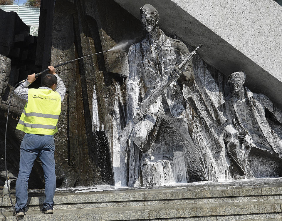 FILE - In this file photo from July 26, 2019, a worker washes a monument dedicated to the fighters of the 1944 Warsaw Rising against the occupying Nazi Germans ahead of ceremonies next week marking the 75th anniversary of the heroic struggle, in Warsaw, Poland. On Thursday Aug. 1, 2019, Warsaw will honour the failed Warsaw Rising, which had been a taboo topic during four decades of communist rule imposed on Poland after the war.(AP Photo/Czarek Sokolowski, FILE)