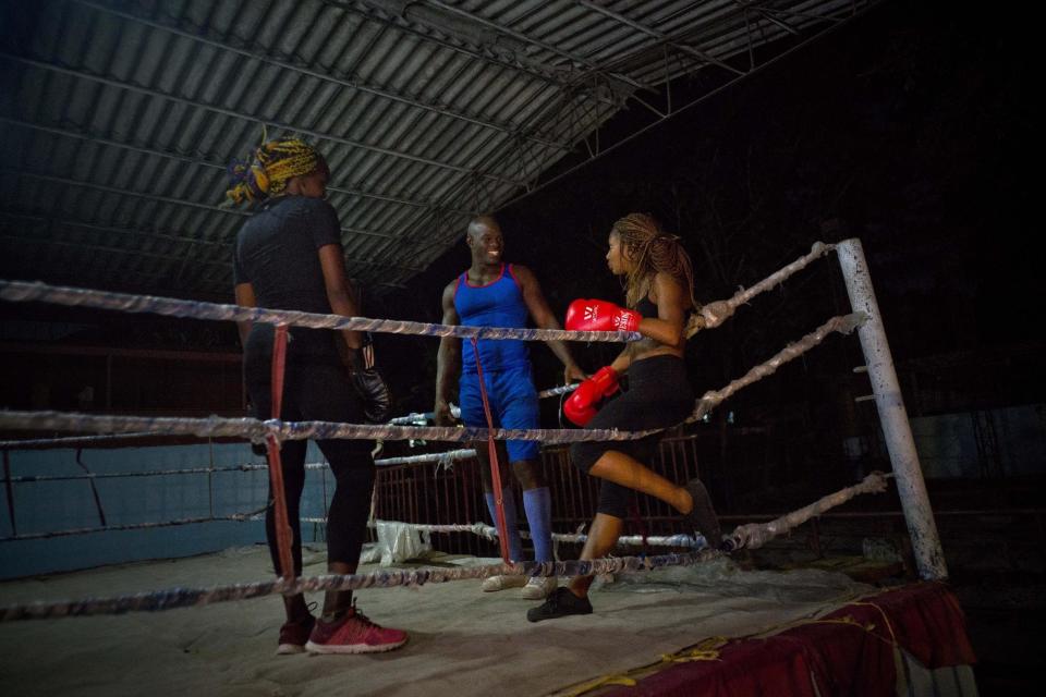 In this Jan. 24, 2017 photo, Olympic silver medalist Emilio Correa Jr., center, instructs Idamelys Moreno, right, and Legnis Cala, at a sports center in Havana, Cuba. Once when the women were kicked out a of boxing gym, Correa Jr. stepped in to help some of them find another gym while they push top Cuban officials to support female boxing. (AP Photo/Ramon Espinosa)