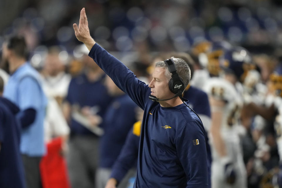 Toledo head coach Jason Candle signals from the sideline during the second half of the Mid-American Conference championship NCAA college football game against Ohio, Saturday, Dec. 3, 2022, in Detroit. (AP Photo/Carlos Osorio)