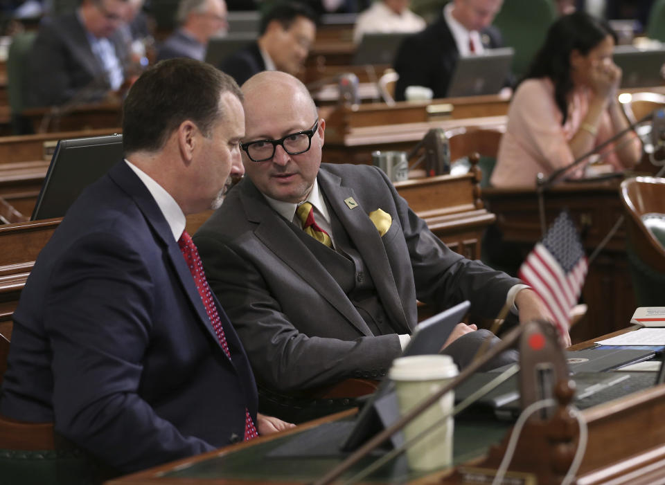 Assembly Republican Leader Brian Dahle, of Bieber, left, talks with Assemblyman Matthew Harper, R-Huntington Beach, during the Assembly session Friday, Aug. 31, 2018, in Sacramento, Calif. Friday is the final day for California lawmakers to consider bills before they adjourn until after the November elections. (AP Photo/Rich Pedroncelli)