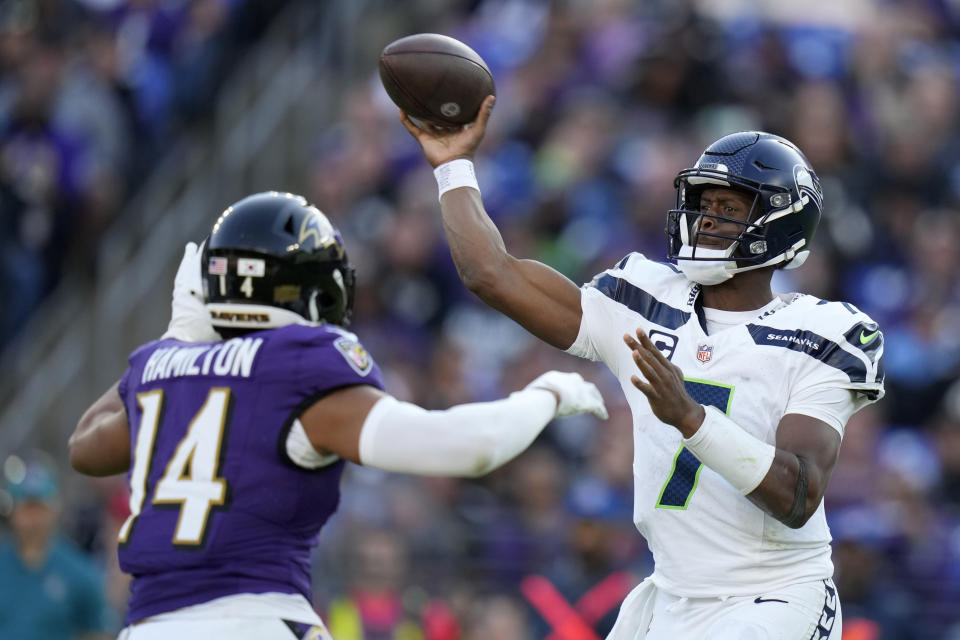 Seattle Seahawks quarterback Geno Smith (7) throws a pass over Baltimore Ravens safety Kyle Hamilton (14) during the second half of an NFL football game, Sunday, Nov. 5, 2023, in Baltimore. (AP Photo/Alex Brandon)