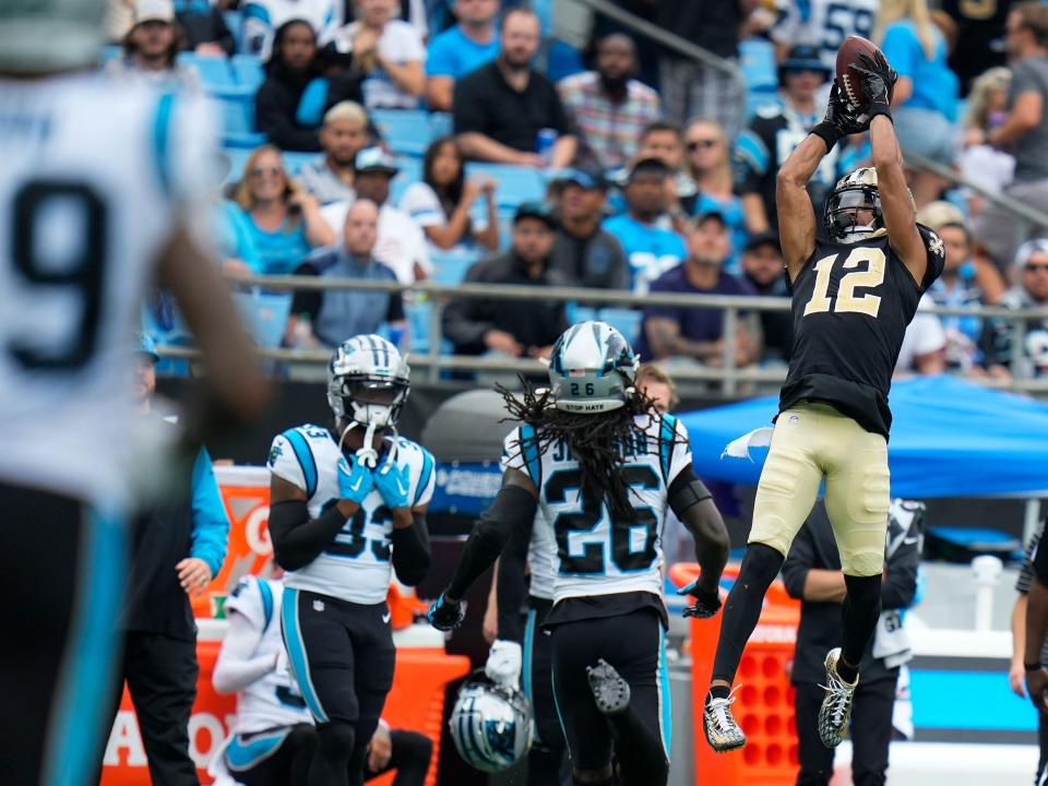 Chris Olave reels in a catch against the Carolina Panthers.