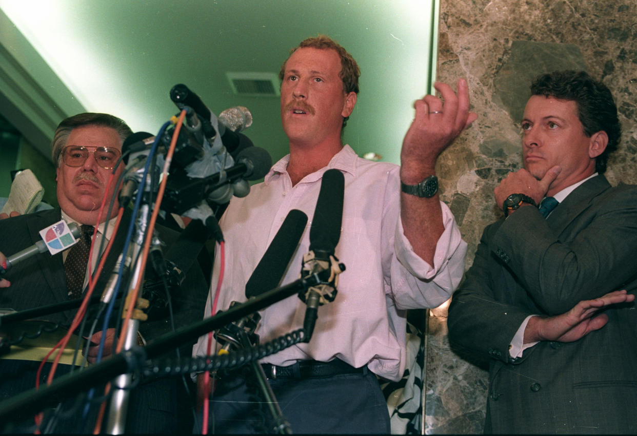 Amateur cameraman George Holliday (C), who captured the beating of Rodney King by Los Angeles Police officers on videotape March 3, and his attorney James Jordan face reporters during a press conference. (Reuters/Lee Celano)