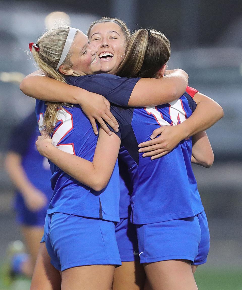 Revere's Hailey Janke, Kayla Smith, and Taylor Catlett celebrate a first-half goal against Westlake in a Division I sectional final Thursday in Bath Township.