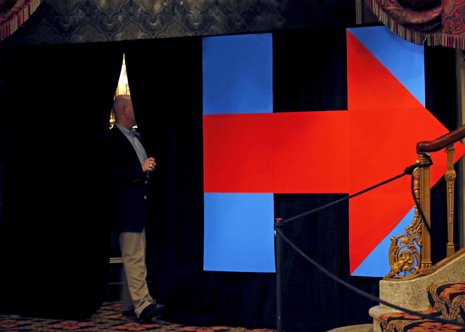 A Secret Service agent checks the backstage at a campaign event