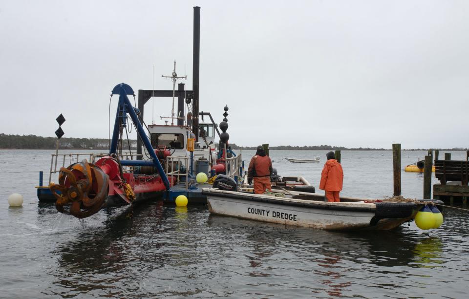 A $714,200 dredging project in Cotuit Bay is underway. Crews were readying the Barnstable County dredge, left, on Thursday along the Town Dock.