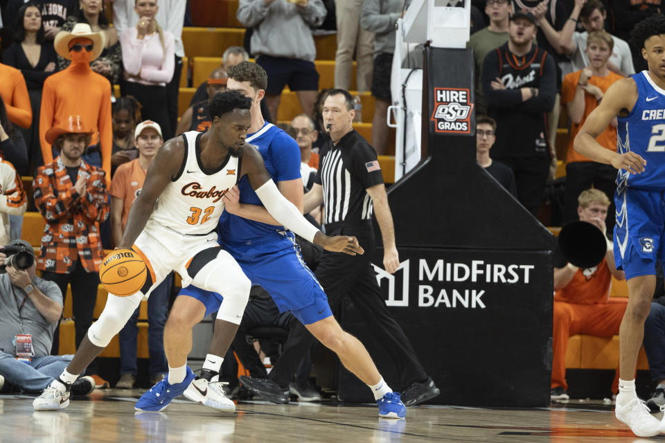 Creighton center Ryan Kalkbrenner guards Oklahoma State center Mike Marsh (32) in the first half of an NCAA college basketball game, Thursday, Nov. 30, 2023, in Stillwater, Okla. (AP Photo/Mitch Alcala)