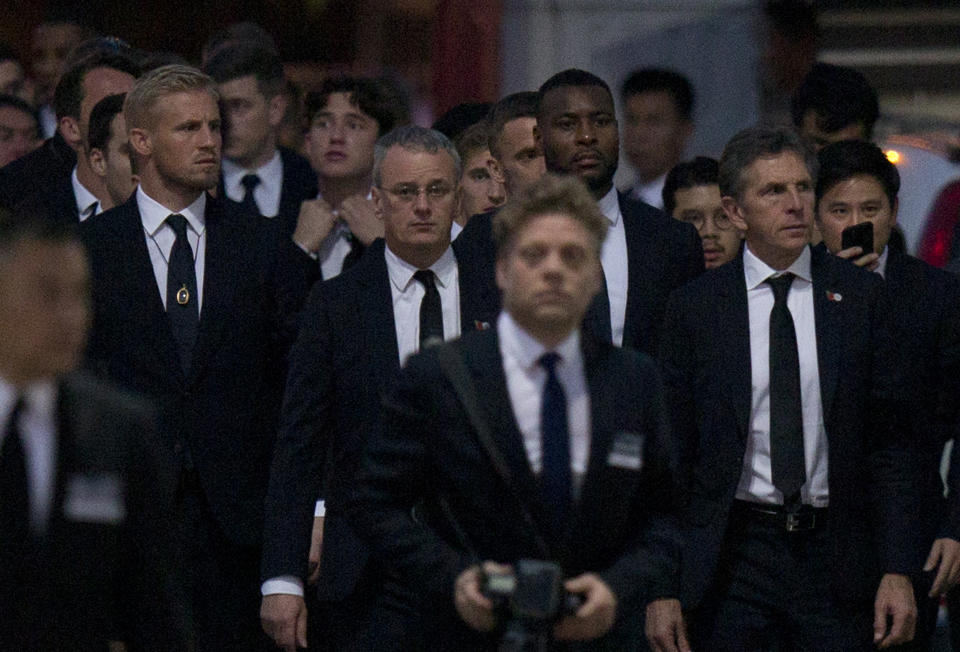 Players and officials of the English Premier League club Leicester City arrive at a Buddhist temple to participate in the funeral rituals of Vichai Srivaddhanaprabha in Bangkok, Thailand, Sunday, Nov. 4, 2018. An elaborate funeral began Saturday for Thai billionaire and Leicester City owner Vichai Srivaddhanaprabha, who died last week when his helicopter crashed in a parking lot next to the English Premier League club's stadium. (AP Photo/Gemunu Amarasinghe)