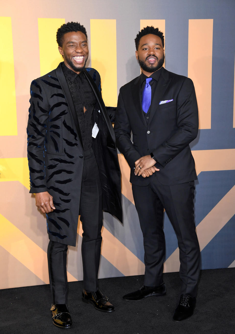 Chadwick smiling widely as he stands next to Ryan