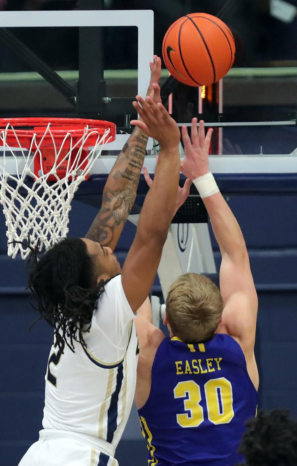 Akron Zips guard Greg Tribble blocks the shot ofSouth Dakota State guard Charlie Easley during the second half of an NCAA college basketball game, Monday, Nov. 7, 2022, in Akron, Ohio.