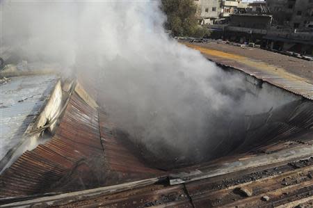 A view shows smoke rising after a mortar shell hit a textile factory at al-Dweil'a neighbourhood in Damascus on Sunday November 3, 2013, causing a huge fire in the factory, but no one was hurt, state media said, in this handout released by Syria's national news agency SANA. REUTERS/SANA/Handout via Reuters