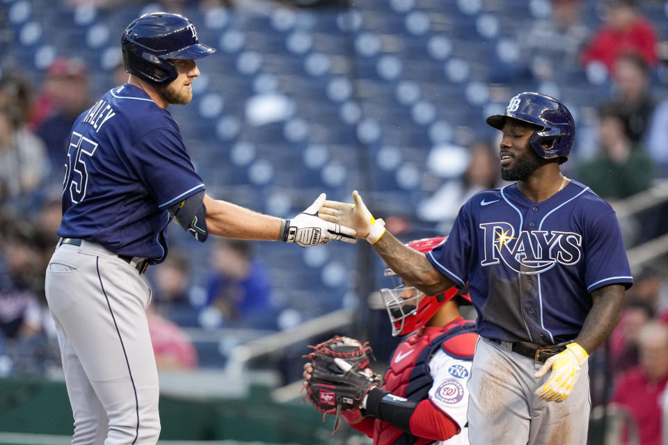 Tampa Bay Rays Luke Raley, left, and Randy Arozarena celebrate after Raley hit a two-run homer during the first inning of a baseball game against the Washington Nationals at Nationals Park, Monday, April 3, 2023, in Washington.(AP Photo/Alex Brandon)