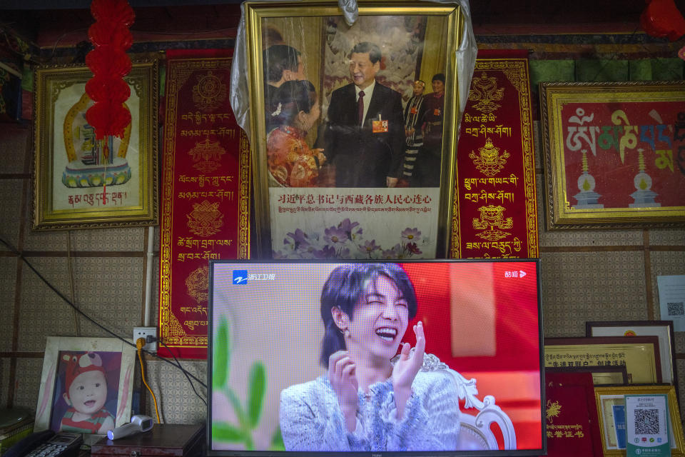 A television shows a broadcast of a Chinese talk show program as it sits beneath a photo of Chinese President Xi Jinping in a home converted into a tourist homestay in Zhaxigang village near Nyingchi in western China's Tibet Autonomous Region, as seen during a rare government-led tour of the region for foreign journalists, Friday, June 4, 2021. Long defined by its Buddhist culture, Tibet is facing a push for assimilation and political orthodoxy under China's ruling Communist Party. (AP Photo/Mark Schiefelbein)