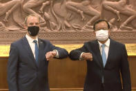 In this image made from video, Britain Foreign Secretary Dominic Raab, left, and Cambodia Foreign Minister Prak Sokhonn greet each other while social distancing to curb the spread of the coronavirus at the Foreign Ministry, Wednesday, June 23, 2021, in Phnom Penh, Cambodia. (AP Photo)