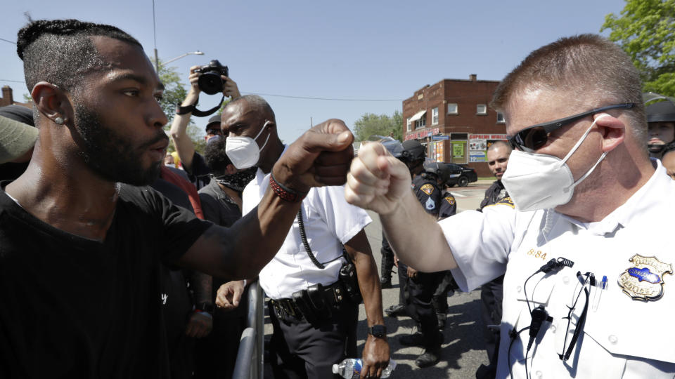 Cleveland Police First District Commander Daniel Fay, right, and a protester give each other a fist bump during a rally for black lives, Tuesday, June 2, 2020, in Cleveland. The City of Cleveland extended its curfew through Tuesday night after riots broke out on Saturday over the death of George Floyd. Floyd died after being restrained by Minneapolis police officers on May 25. (AP Photo/Tony Dejak)