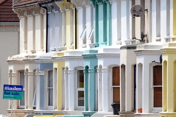 a for sale sign outside houses in Brighton