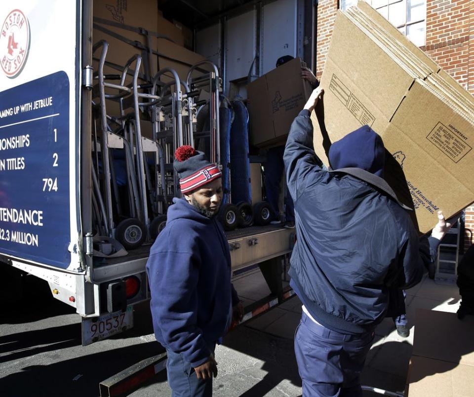 Workers load the Boston Red Sox baseball equipment truck outside Fenway Park on Monday morning. The annual truck day marks the beginning of the truck's journey to the team's spring training facility in Fort Myers, Fla. [Steven Senne/Associated Press]