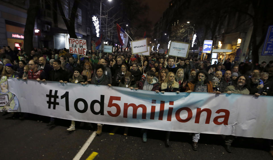 People hold a banner that reads: ''#1 out of 5 million'' during a protest against populist President Aleksandar Vucic in Belgrade, Serbia, Saturday, Dec. 22, 2018. Thousands of people have rallied in another protest in Serbia against populist President Aleksandar Vucic accusing him of stifling hard-won democratic freedoms and cracking down on opponents. (AP Photo/Darko Vojinovic)