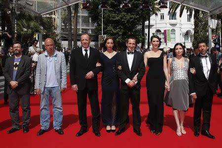 (3rdL-R) Producer Alain Sarde, cast members Christian Gregori, Jessica Erickson, Richard Chevallier, Zoe Bruneau, Heloise Godet and Kamel Abdelli pose on the red carpet as they arrive for the screening of the film "Adieu au langage" (Goodbye to Language) in competition at the 67th Cannes Film Festival in Cannes May 21, 2014. REUTERS/Benoit Tessier