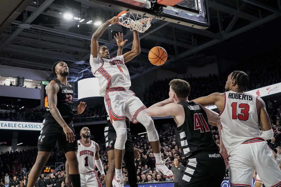 Houston forward Ja'Vier Francis, center, dunks during the second half of an NCAA basketball game against Cincinnati, Saturday, Feb. 10, 2024, in Cincinnati. (AP Photo/Joshua A. Bickel)