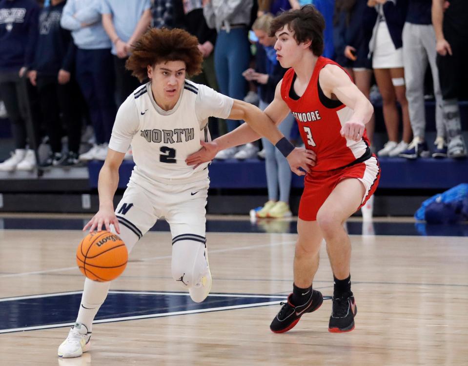 Edmond North's T.O. Barrett drives up court as Westmoore's Gavin Loper defends during a 65-55 win Friday night in Edmond.