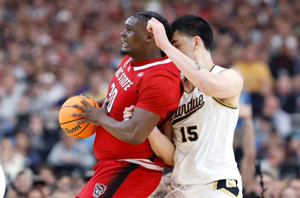 N.C. State’s DJ Burns Jr. (30) works against Purdue’s Zach Edey (15) during the first half of N.C. State’s game against Purdue in the NCAA Tournament national semfinals at State Farm Stadium in Glendale, Ariz., Saturday, April 6, 2024.