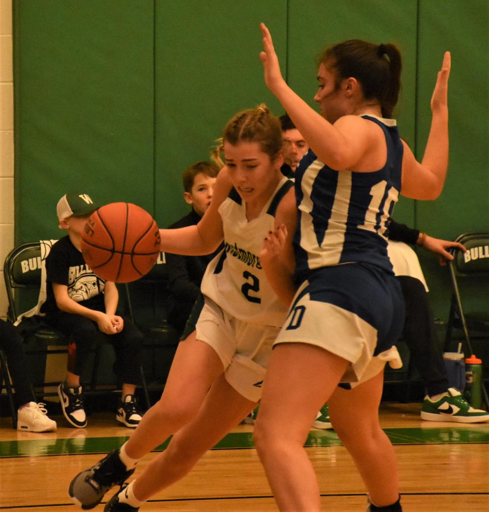 Westmoreland Bulldog Jacqueline Downs (left) drives against Dolgeville defender Alexandia Comstock during the second half of Monday's game in Westmoreland.