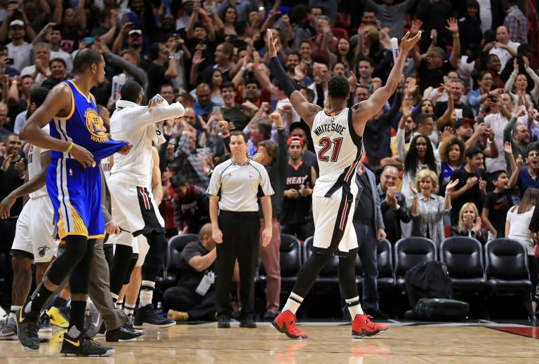 The Miami Heat players celebrate after winning their NBA game against the Golden State Warriors, at American Airlines Arena in Miami, Florida, on January 23, 2017