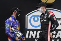 Josef Newgarden, right, talks with Alexander Rossi following an IndyCar auto race at Indianapolis Motor Speedway, Friday, Oct. 2, 2020, in Indianapolis. Newgarden won the race, and Rossi finished second. (AP Photo/Darron Cummings)
