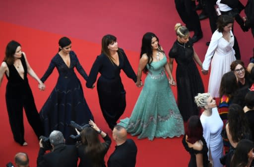 Female actresses including Salma Hayek Pinault, wearing sea green, and Sofia Boutella, on her left, protest the lack of female filmmakers honored at Cannes film festival