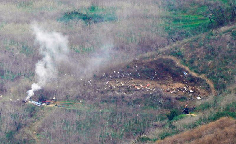 FILE PHOTO: Los Angeles county firefighters arrive on the scene of a helicopter crash that killed retired basketball star Kobe Bryant in Calabasas